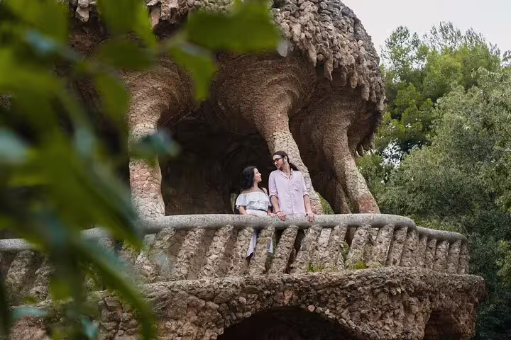 Couple posing at Park Güell stone terrace on a private Barcelona photo tour with personal photographer