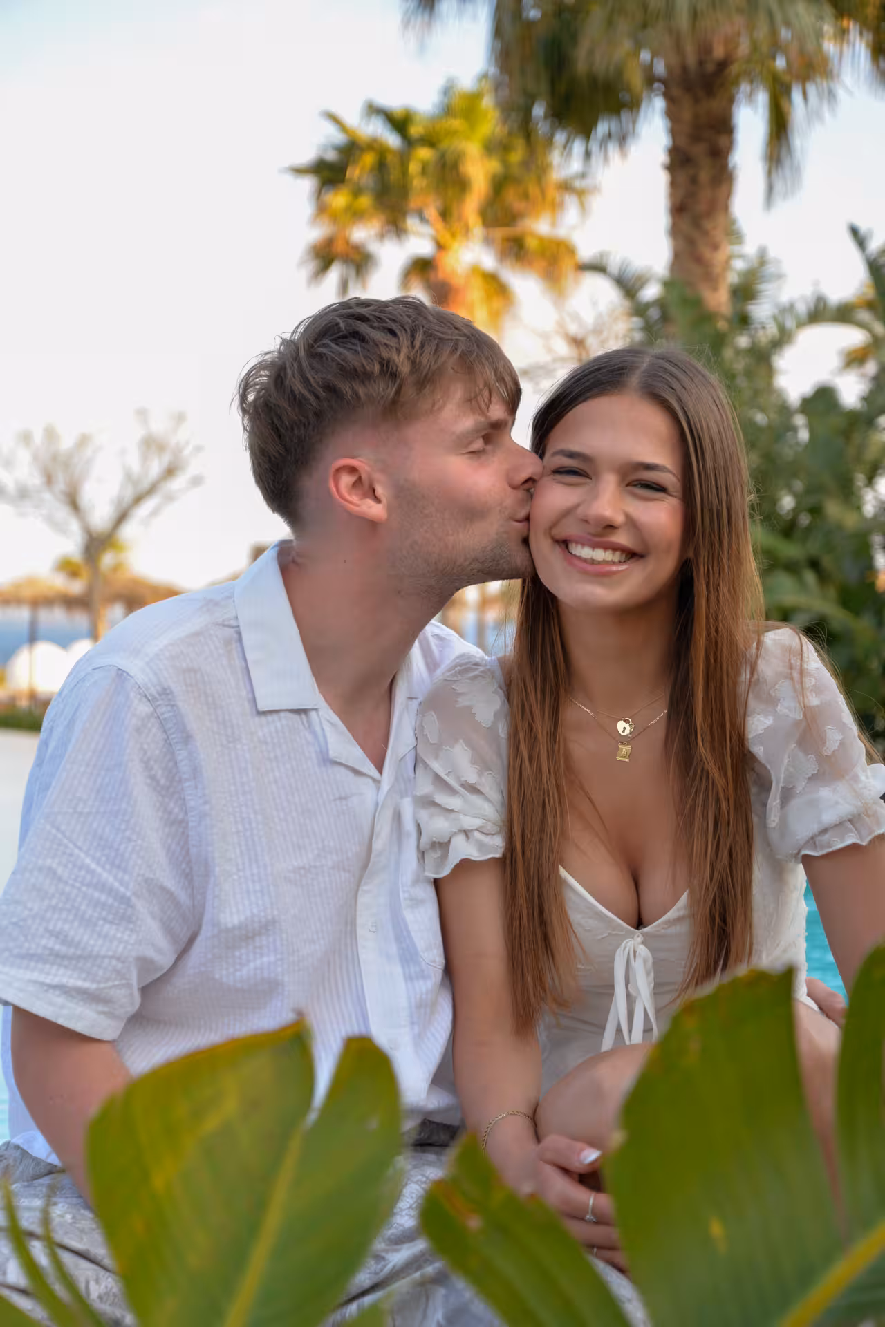 Couple smiling by the pool at Heraklion Venetian Port, capturing a romantic photoshoot moment.