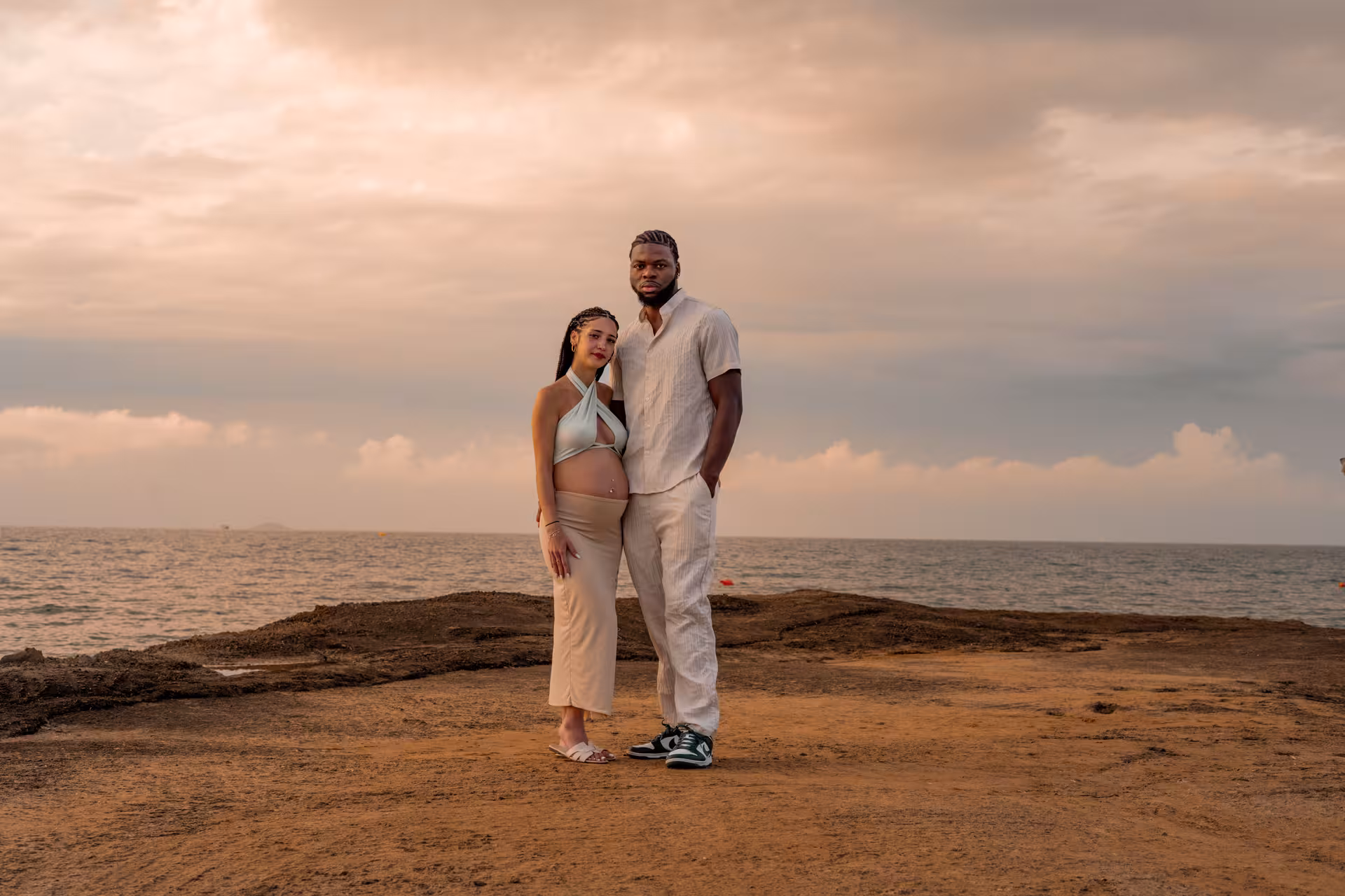 Couple posing by the sea at Heraklion Venetian Port during sunset, capturing a romantic and memorable photoshoot.