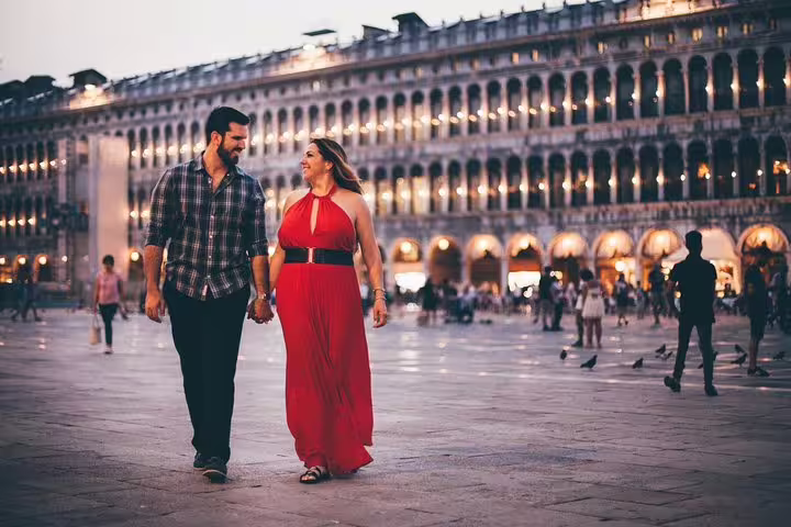 Couple walking in Piazza San Marco at dusk, Venice private tour with personal travel photographer photo shoot