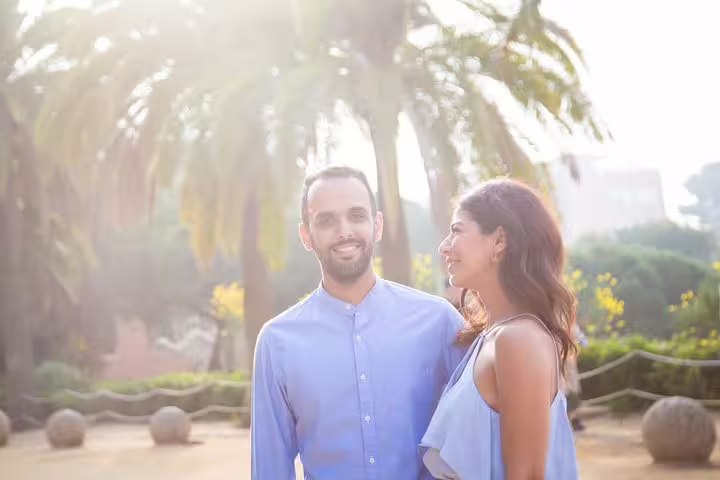 Couple portrait in sunny Barcelona park with palm trees, shot on private tour with personal travel photographer