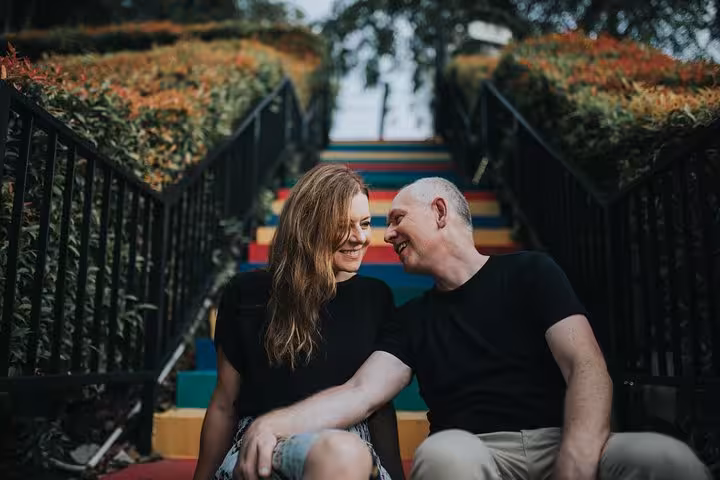 Couple portrait on colorful rainbow stairs in Singapore with personal travel photographer vacation tour