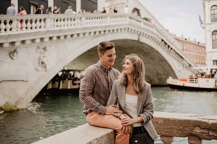 Couple portrait at Rialto Bridge canalfront on a private Venice travel photographer walking tour