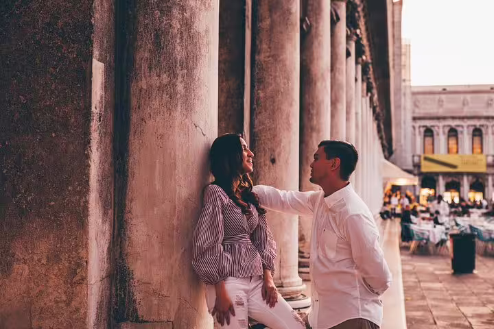 Couple portrait under Venice colonnade near St Mark’s Square on a private travel photographer photo tour
