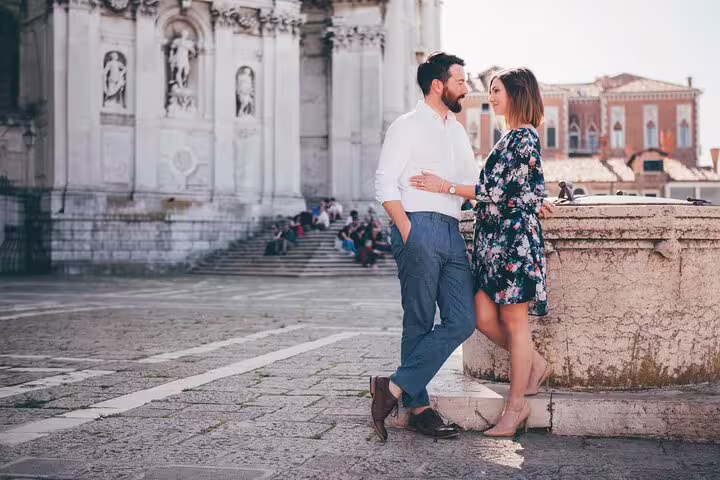 Couple portrait in Venice near historic church, part of private gondola ride with professional photographer