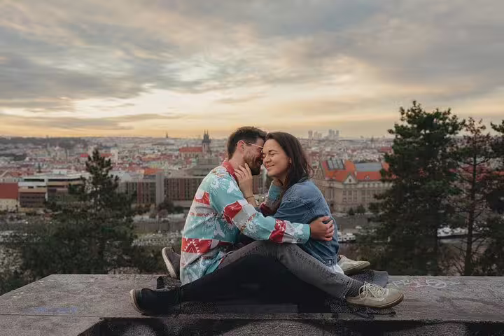 Couple shares a tender moment overlooking a scenic Prague skyline at sunset during a private photography session.