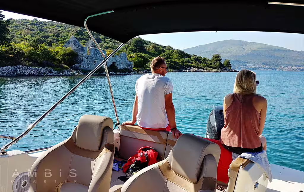Couple relaxing on private boat near Šolta coastline, Blue Lagoon cruise with swim stop and island hopping