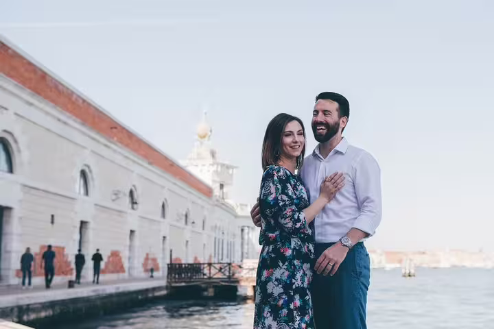 Couple posing by Venice waterfront near San Marco, private gondola ride with professional photographer session