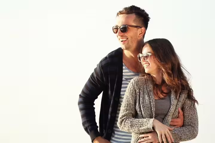 Couple laughing in sunglasses during a private Melbourne travel photographer tour, capturing candid portraits
