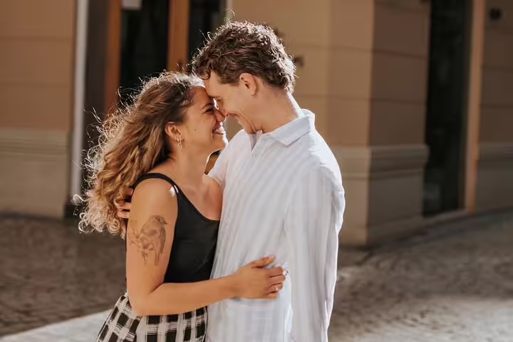 Couple sharing a tender moment during a professional photoshoot in sunny Marbella.