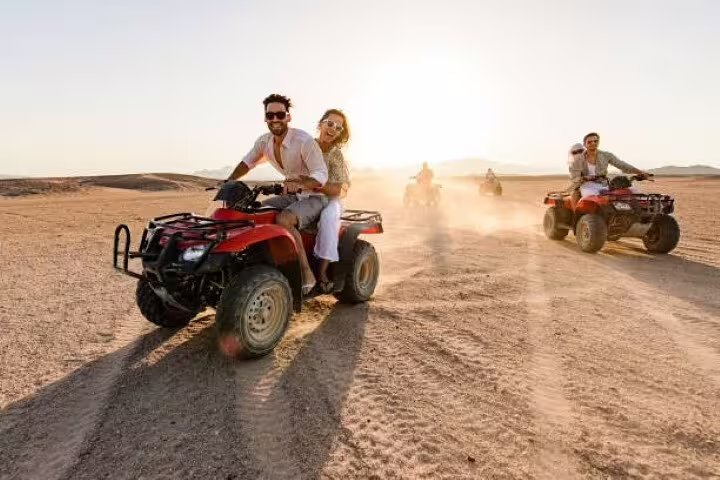 Couple on quad bike leading group across Sinai Desert, private ATV safari tour from Sharm El Sheikh