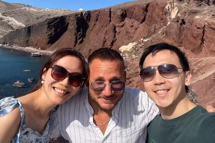Couple with guide at Santorini Red Beach viewpoint on a private Athens to Santorini sightseeing and wine tour