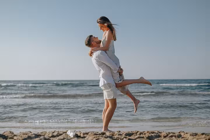Couple enjoying a romantic beach moment during a private photoshoot in Anisaras.