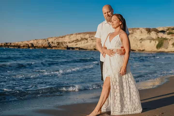 Couple enjoying a romantic beach moment in Hersonissos during a private photoshoot, perfect for capturing love and travel.