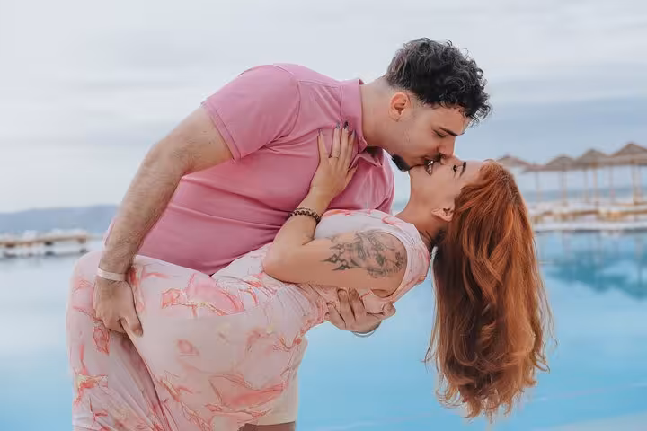 Couple sharing a romantic kiss by the pool in Hersonissos, ideal setting for a private photoshoot and unforgettable memories.