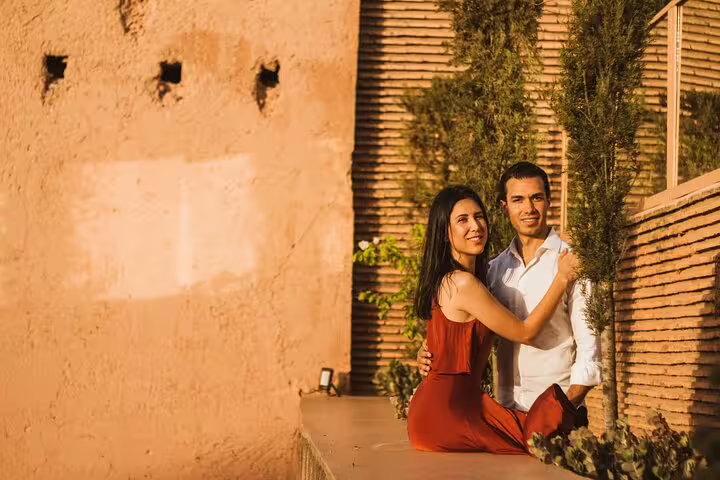 Couple embracing against a rustic Marrakesh backdrop, capturing romantic moments with vacation photography.