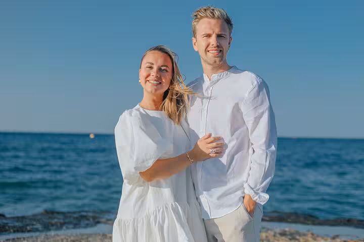 Happy couple posing together on Agios Nikolaos beach, capturing romantic moments in a private photoshoot by the sea.