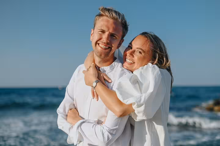 Happy couple posing by the sea in Agios Nikolaos, ideal for a romantic and scenic private photoshoot session.