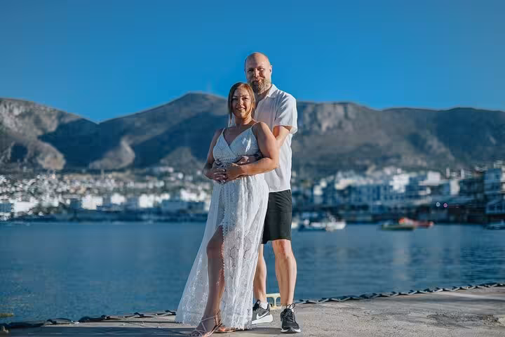 Couple posing by the scenic Hersonissos waterfront, ideal for a romantic private photoshoot in Crete.