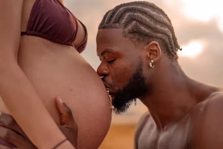 Couple enjoying a romantic sunset beach moment during a private photoshoot in Ammoudara.