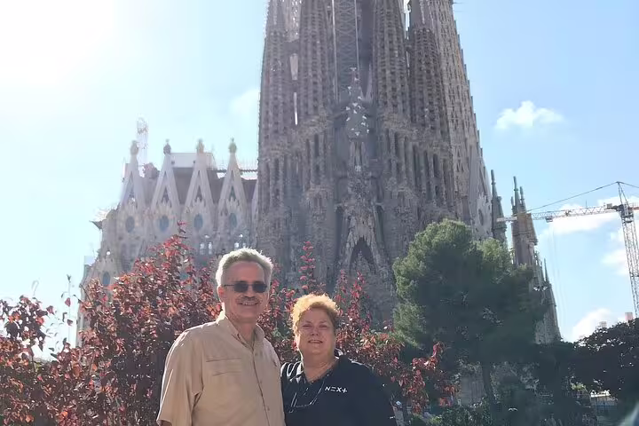 Couple posing in front of the majestic Sagrada Familia, capturing a memorable Barcelona tour moment.