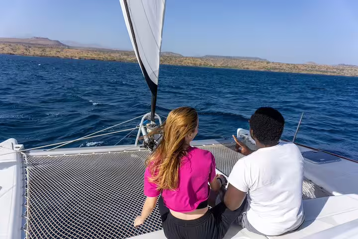 Couple enjoying a scenic sail on the azure waters of Boa Vista, part of a 7-day adventure package.