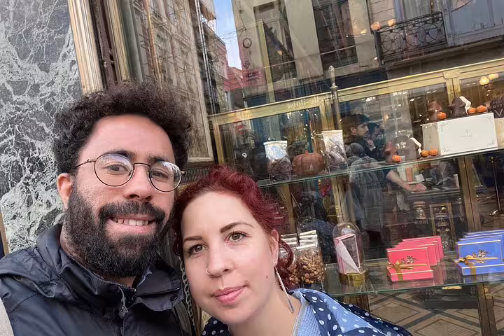 Couple selfie in Old Lille by boutique window, enjoying a Lille scavenger hunt and city highlights walking tour