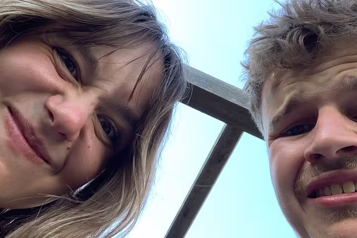 Couple selfie by medieval timber beams during Rothenburg scavenger hunt and sights self-guided tour
