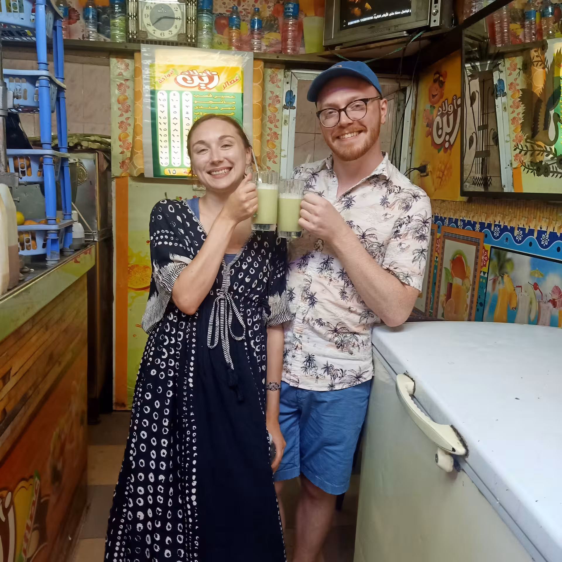 Couple enjoying fresh sugarcane juice at a Cairo street stall on a private food tour and funny walking tour