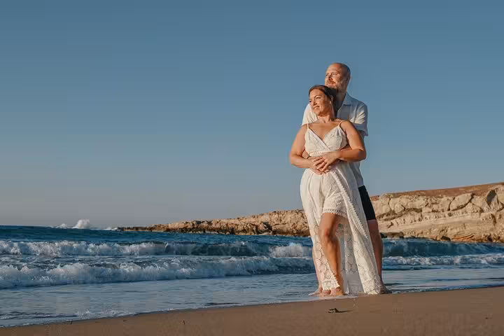 Couple enjoying a sunset beach photoshoot in Hersonissos, capturing romantic moments by the sea.