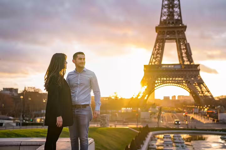 Couple posing at sunset with Eiffel Tower for Paris proposal photographer session and engagement photos