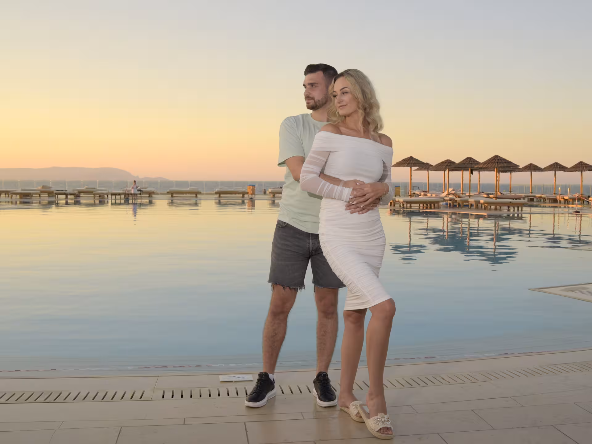 Couple enjoying sunset by the pool at Heraklion Venetian Port, ideal setting for an anniversary photoshoot.