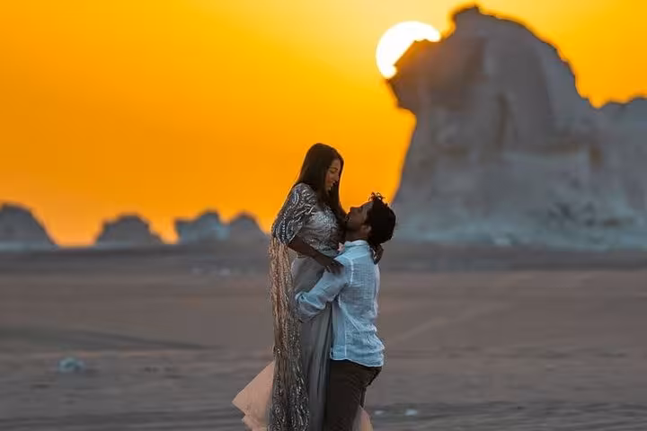 Couple at sunset in Egypt’s White Desert near Bahariya Oasis, romantic eco camping tour backdrop