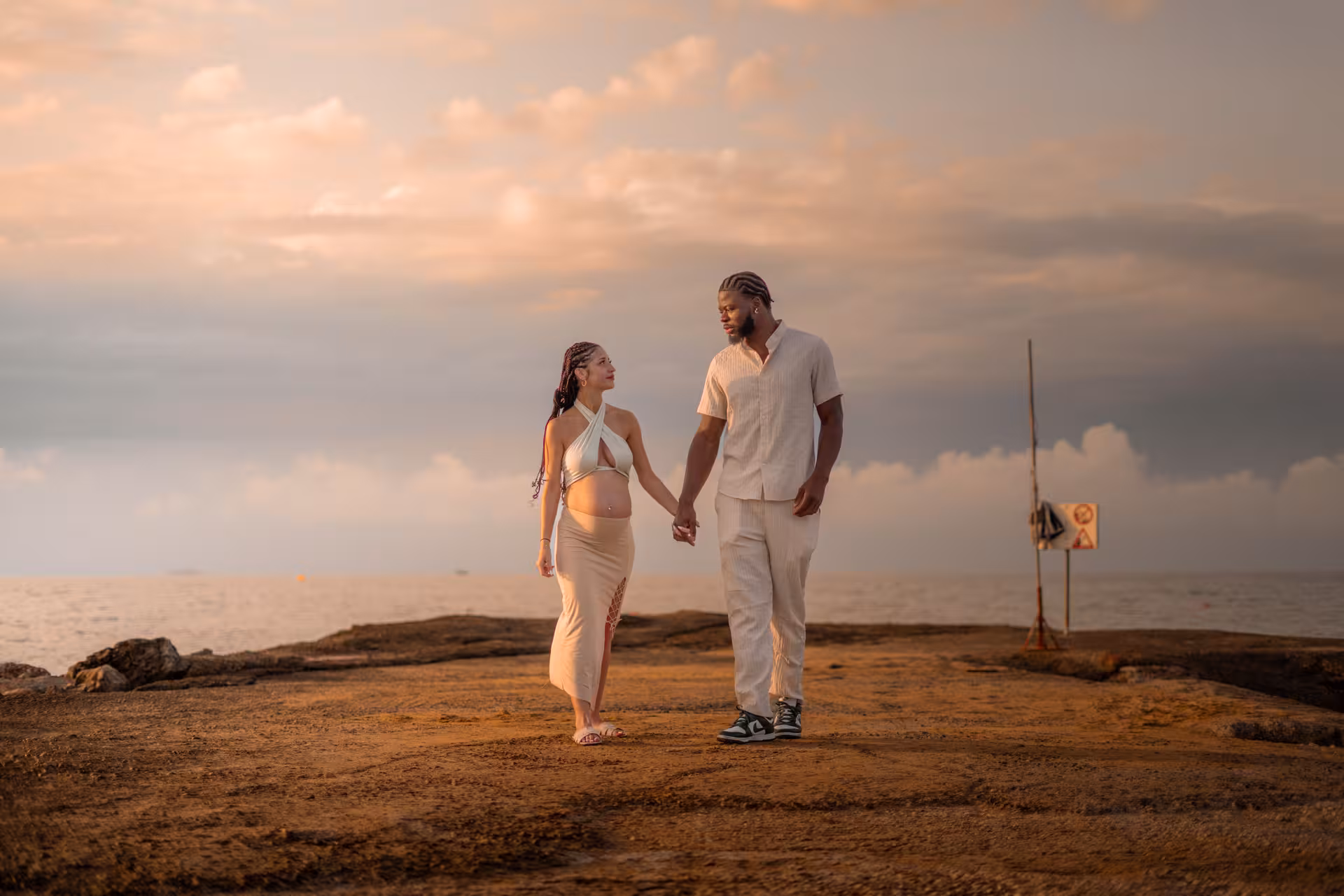 Couple walking hand in hand at Heraklion Venetian Port during a surprise proposal photoshoot.