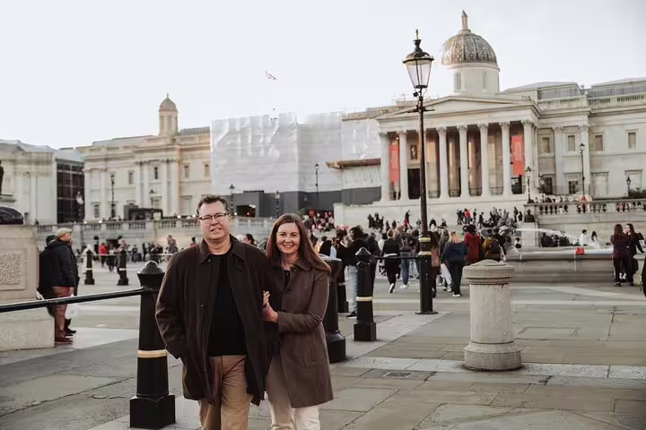 Couple posing at Trafalgar Square in front of the National Gallery, capturing memories on a London photo tour.