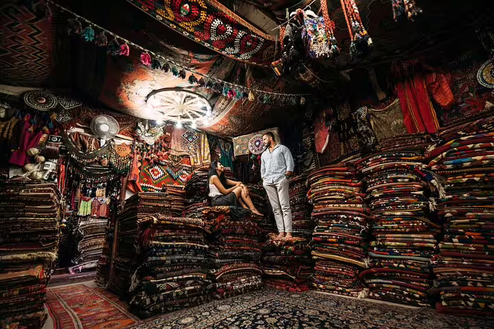 Couple posing among colorful Turkish carpets in Grand Bazaar, Istanbul vacation photographer private tour