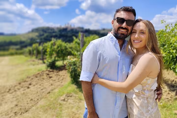 Couple embracing in a picturesque Tuscan vineyard, highlighting romance and scenic views of Chianti.
