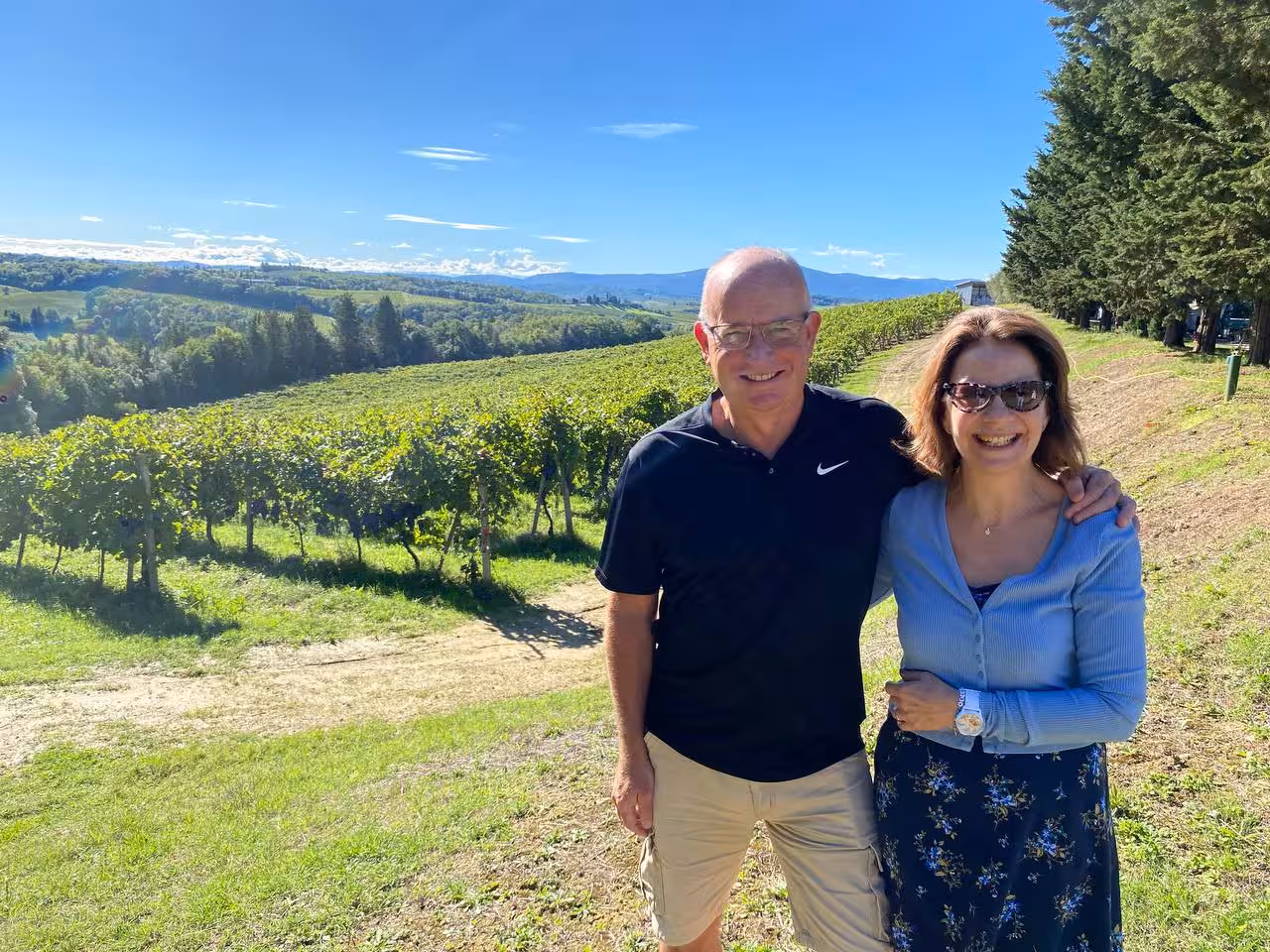 Couple enjoying a sunny day in a lush Tuscan vineyard during a full-day private tour from Florence.