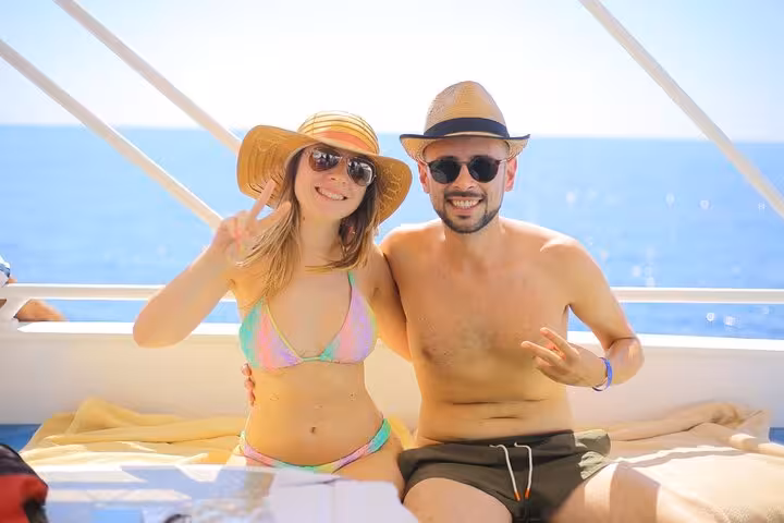 Couple relaxing on yacht sun deck on White Island and Ras Mohamed snorkeling trip from Sharm El Sheikh