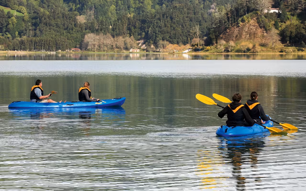 Couples canoeing on calm Furnas Lake, São Miguel Azores, scenic highlight of the Mystic Furnas canoe and bike tour