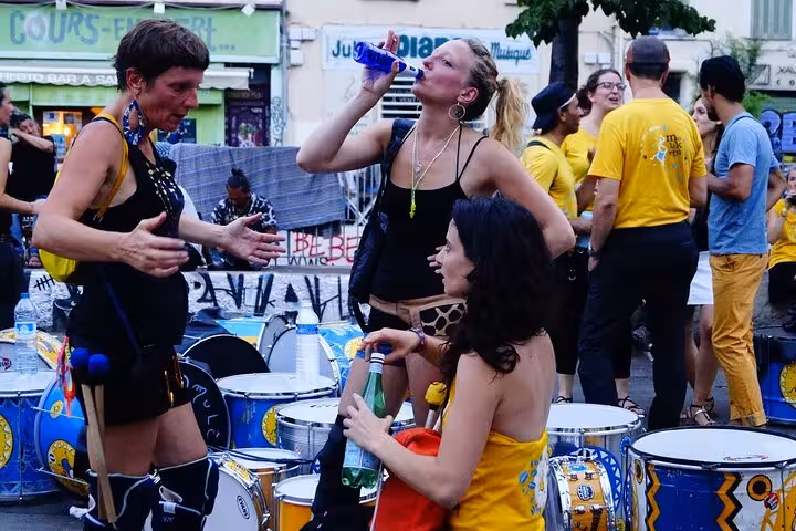 Street drummers and locals at a lively Cours Julien square, Marseille, near Noailles market tour stop