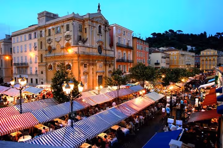 Bustling Cours Saleya Market in Nice at dusk, offering a lively atmosphere for a private food tour.