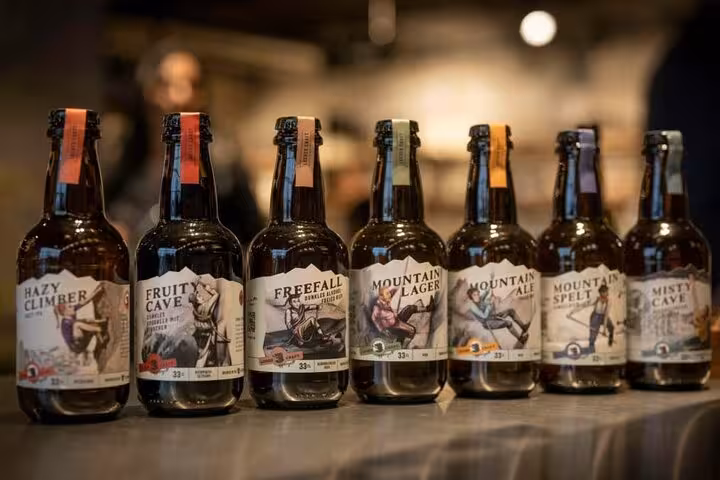 A selection of craft beer bottles lined up at a brewery in St. Gallen, showcasing local flavors and Swiss craftsmanship.