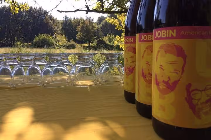 Craft beer bottles and tasting glasses set on outdoor table in a beer garden, local brewery tasting experience