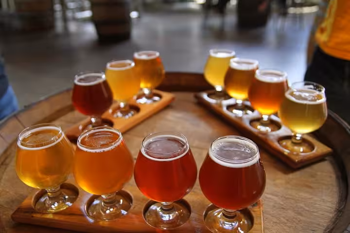 Assorted craft beers on a wooden barrel, part of a tasting session during the Local Craft Beer Walk in Rome.