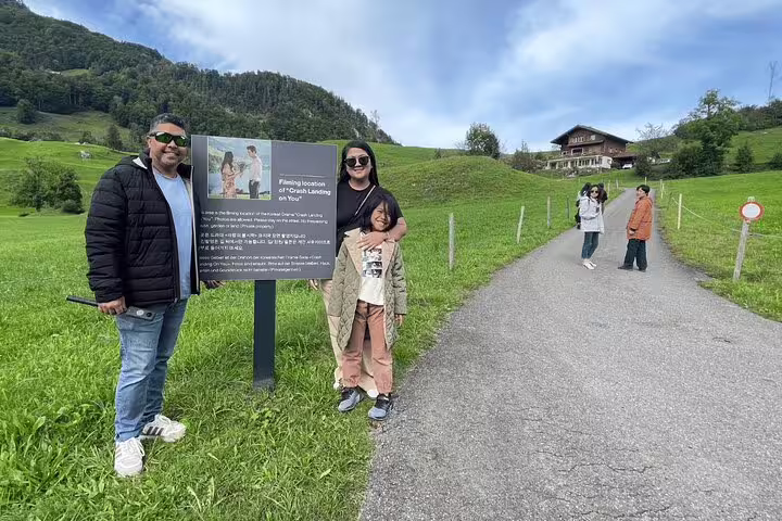 Tourists admire the Crash Landing on You filming site in scenic Interlaken, featuring iconic Swiss landscapes.