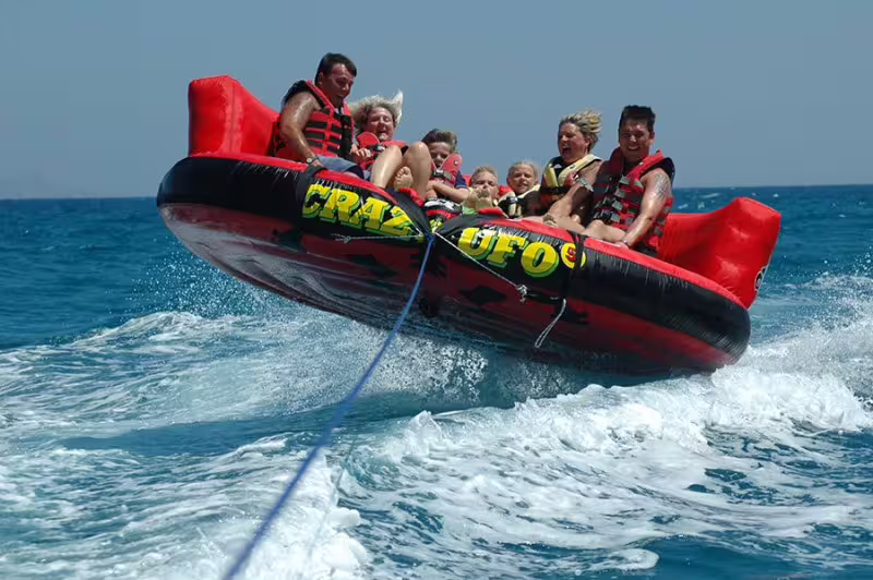 Group rides a Crazy UFO inflatable tube on the Red Sea in Sharm El Sheikh, thrilling water sports day trip