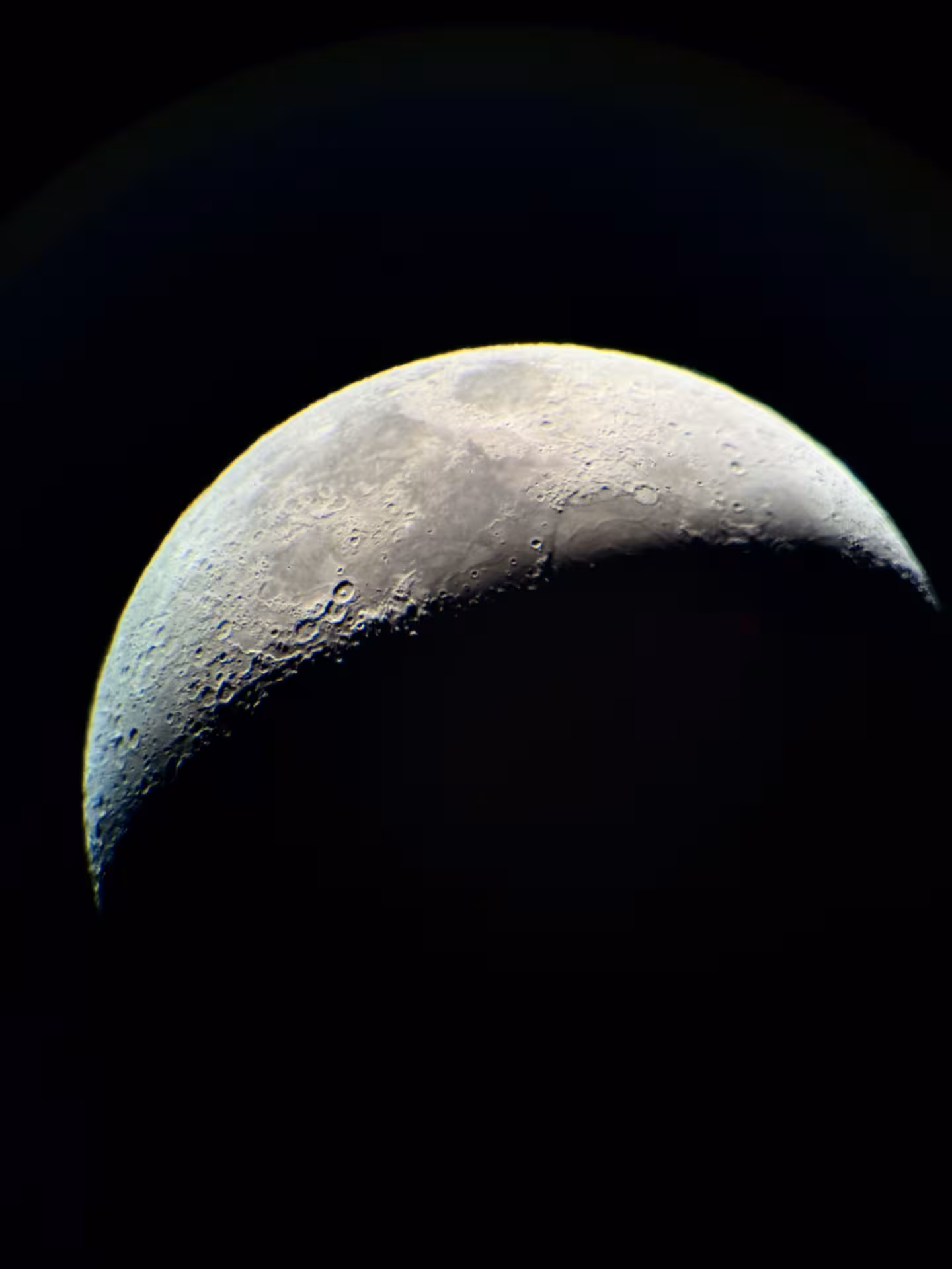 Close-up crescent moon seen through a telescope on a private stargazing experience with guided astronomy
