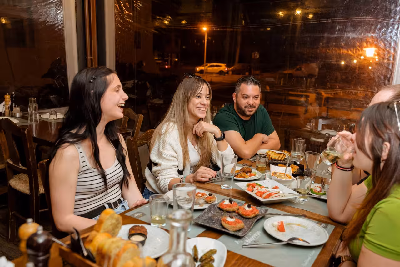 Friends enjoy Cretan meze and wine tasting on a full-day ecobike village tour discovering real Crete