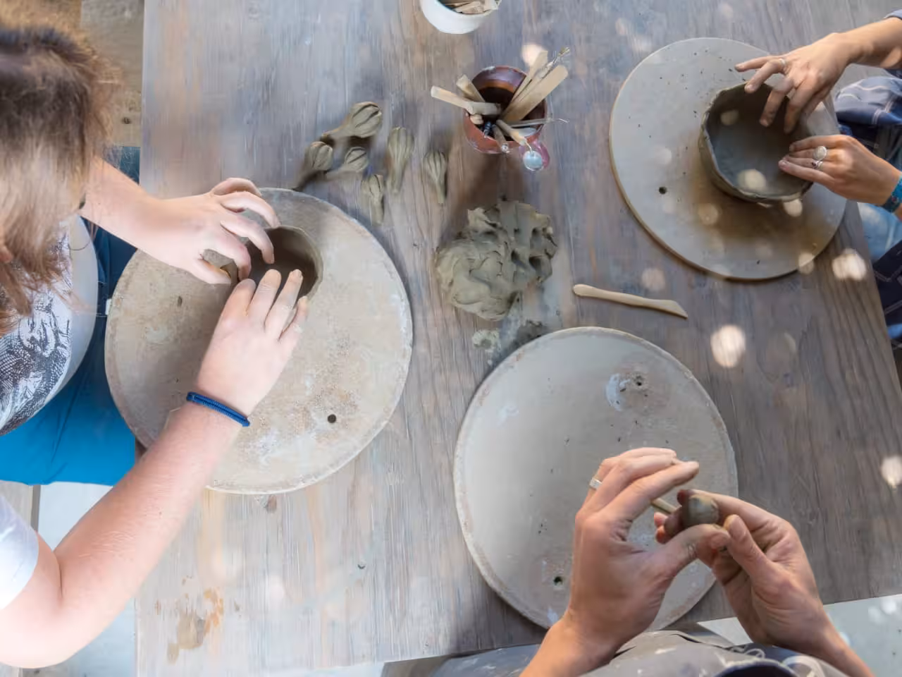 Hands shaping clay bowls in a traditional Cretan pottery workshop, part of a Crete culture day trip